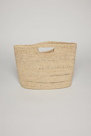 A beige raffia Naomi handheld straw bag by Velvet by Graham & Spencer with horizontal patterns, displayed against a plain white background.