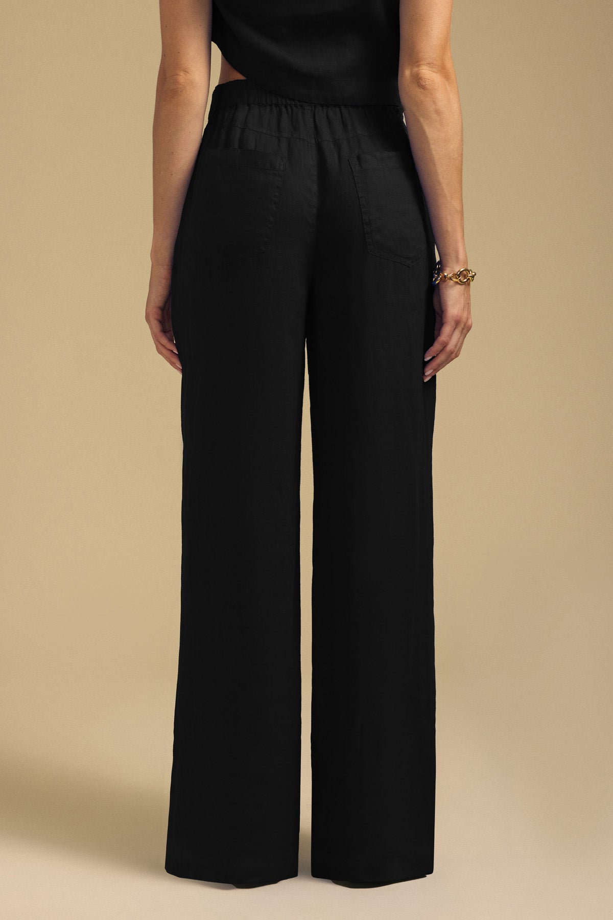 Back view of black wide-leg NATALIE LINEN PANT with an elastic waistband.