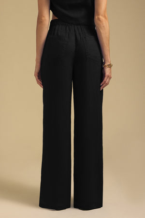 Back view of black wide-leg NATALIE LINEN PANT with an elastic waistband.