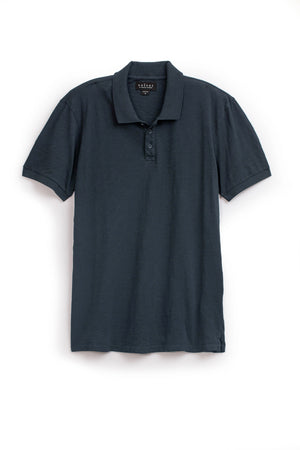 A NIKO POLO by Velvet by Graham & Spencer hanging on a white background.