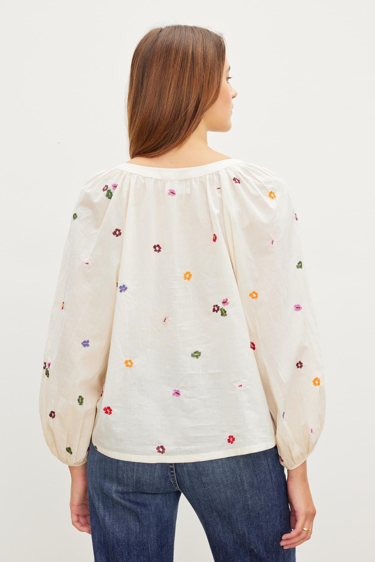   The back view of a woman wearing the Velvet by Graham & Spencer ARETHA EMBROIDERED BOHO TOP. 