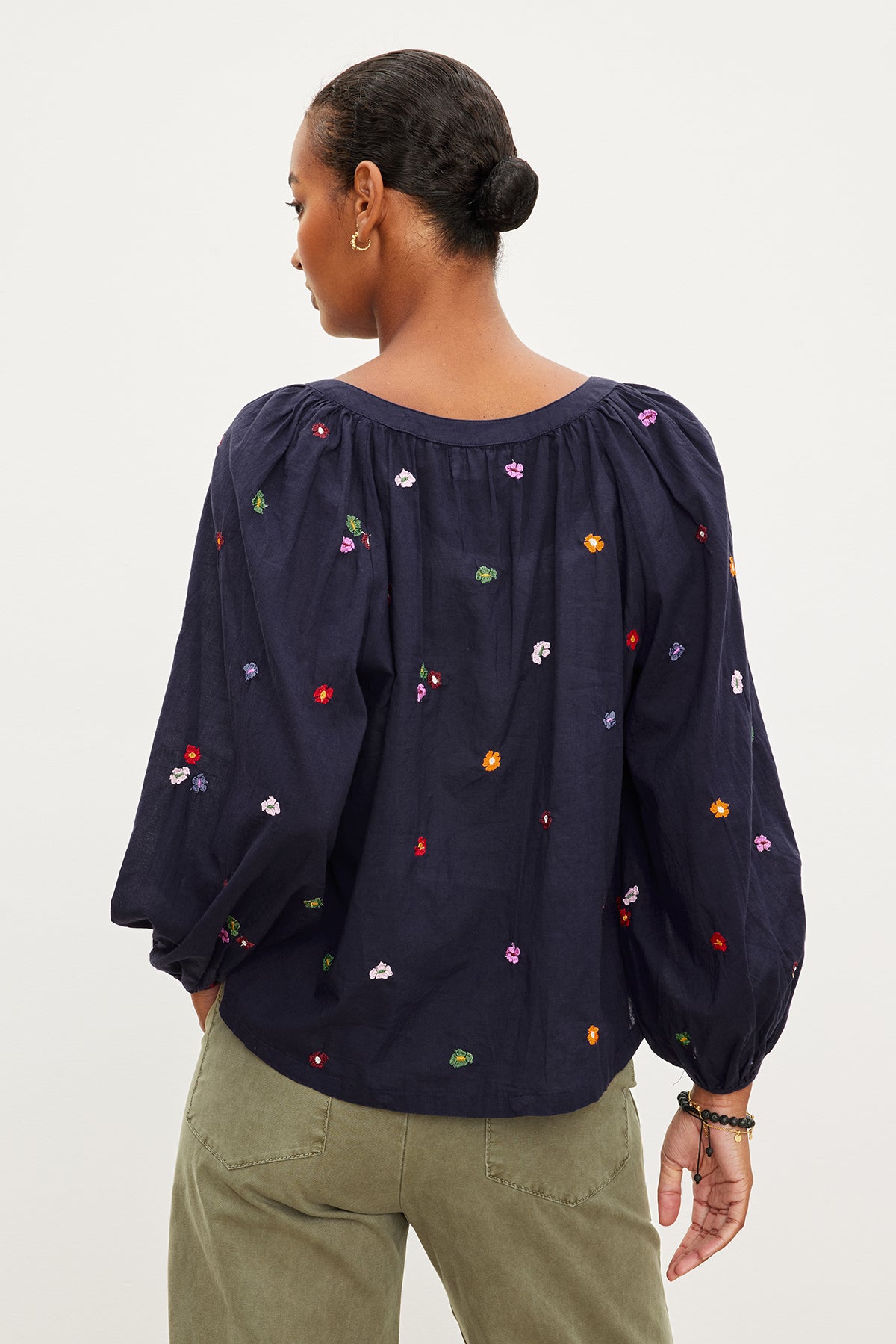   The back view of a woman wearing a Velvet by Graham & Spencer ARETHA EMBROIDERED BOHO TOP. 