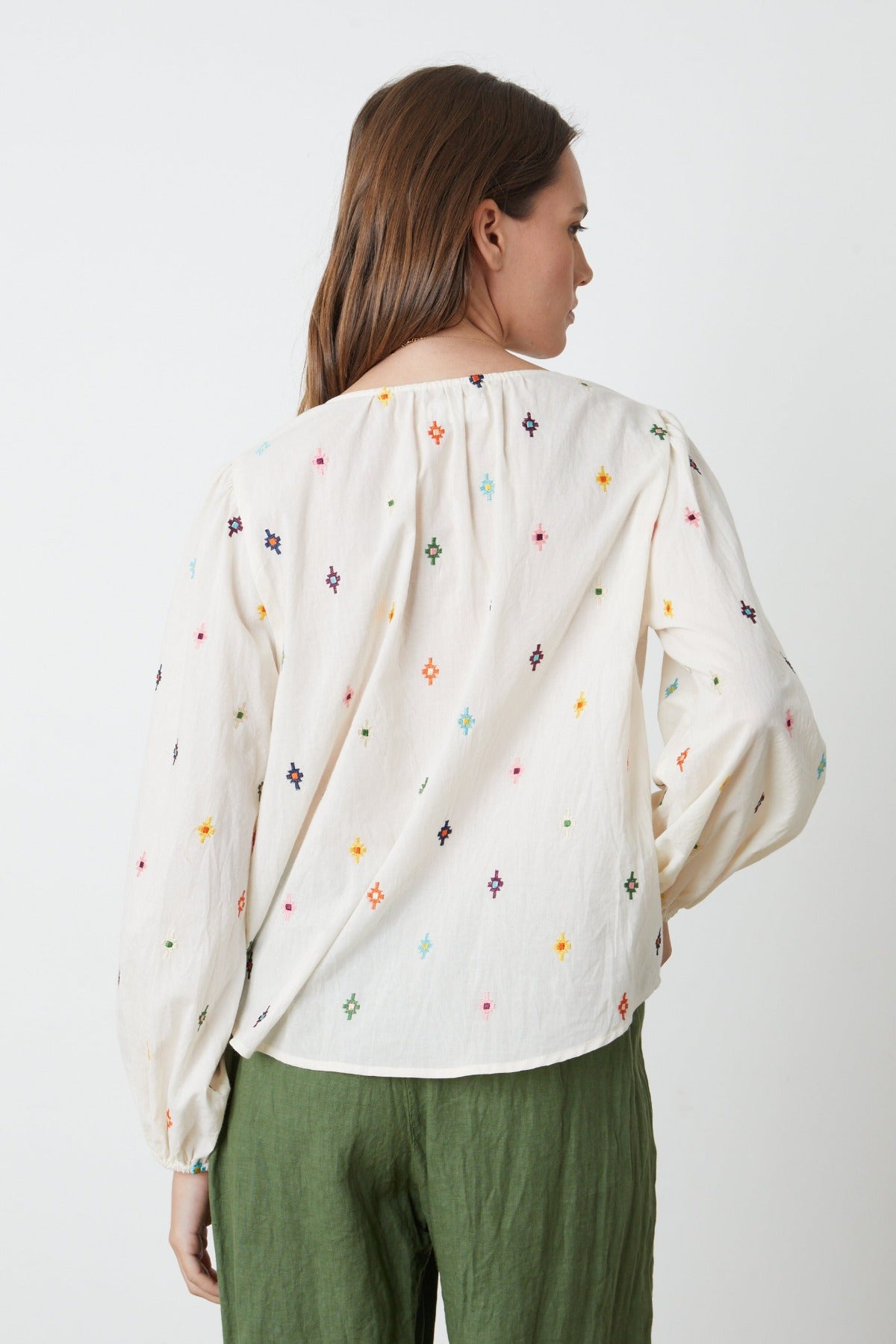 The back view of a woman wearing the Velvet by Graham & Spencer ELIZABETH EMBROIDERED BOHO TOP.-26757374804161