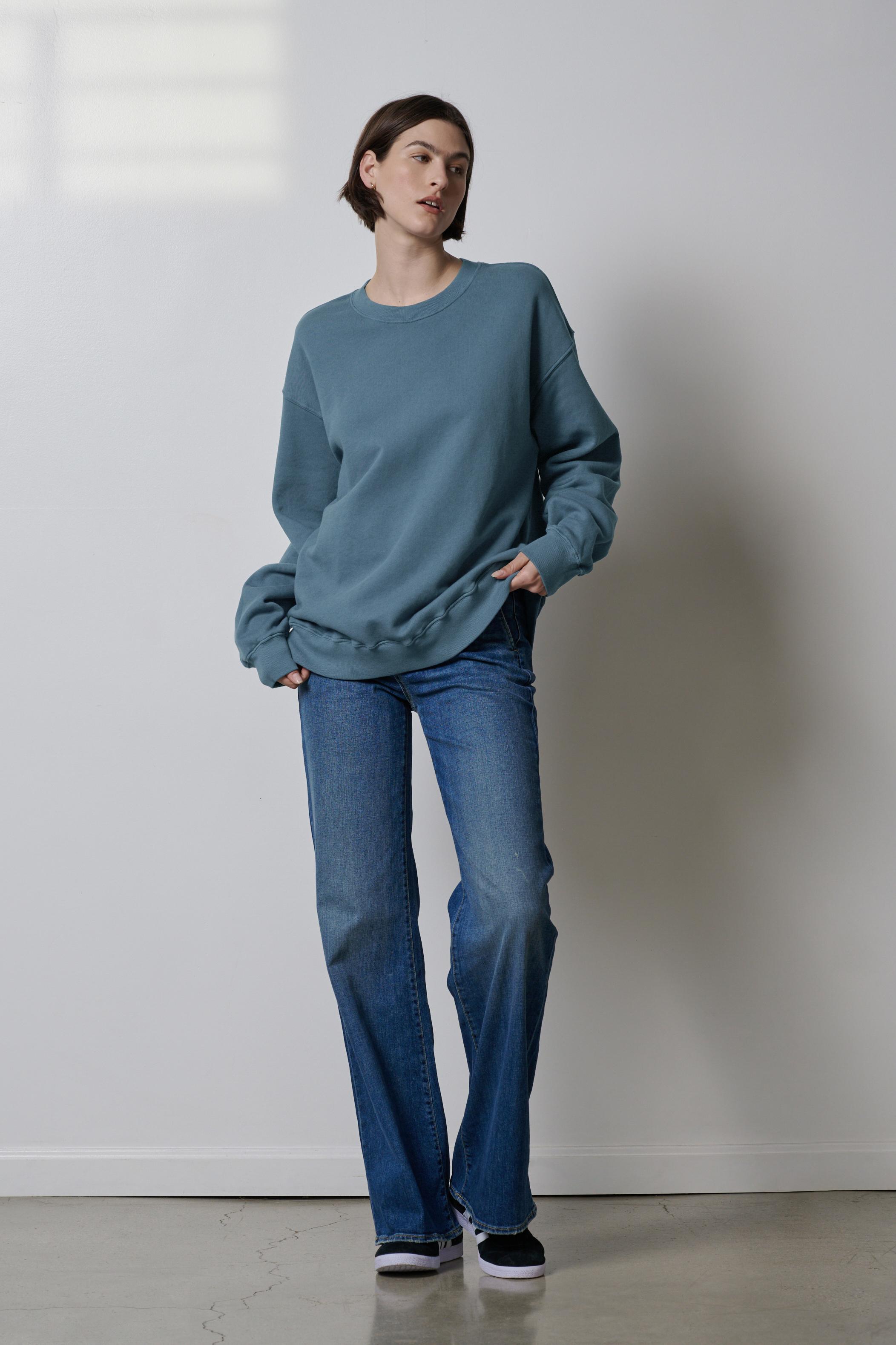   A woman wearing organic cotton blue jeans and a Velvet by Jenny Graham Abbot sweatshirt. 