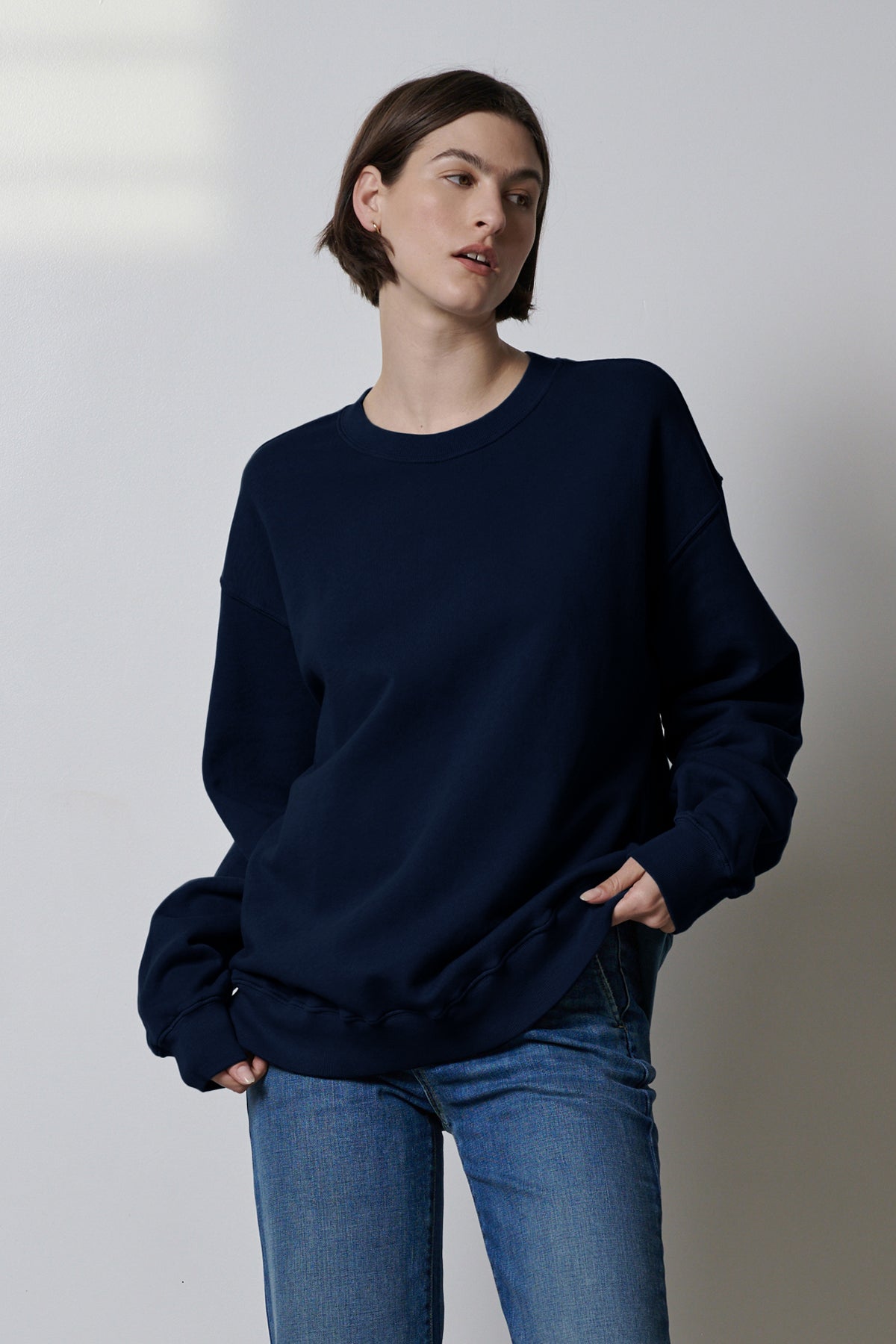 The model is wearing an ABBOT SWEATSHIRT by Velvet by Jenny Graham, showcasing styling versatility.-35495989674177