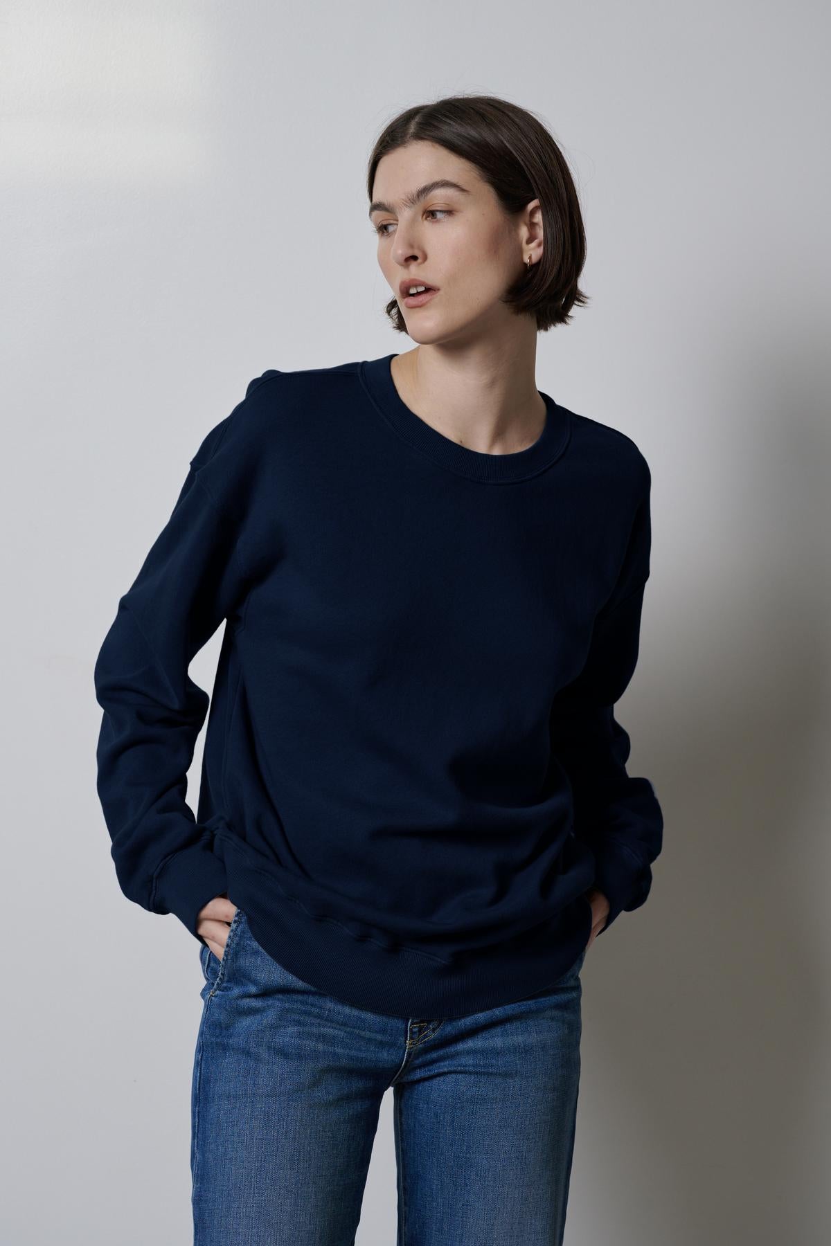   The model is wearing a Velvet by Jenny Graham Abbot sweatshirt, highlighting its styling versatility. 