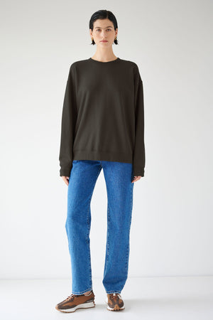 A woman sporting a versatile styling in the Velvet by Jenny Graham Abbot Sweatshirt made of organic cotton.