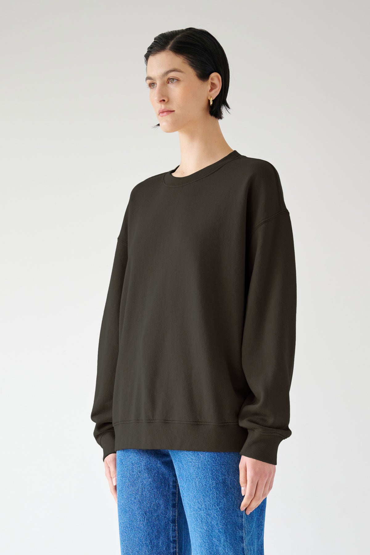 The model is wearing a slouchy black Velvet by Jenny Graham Abbott sweatshirt and jeans.-35200265322689