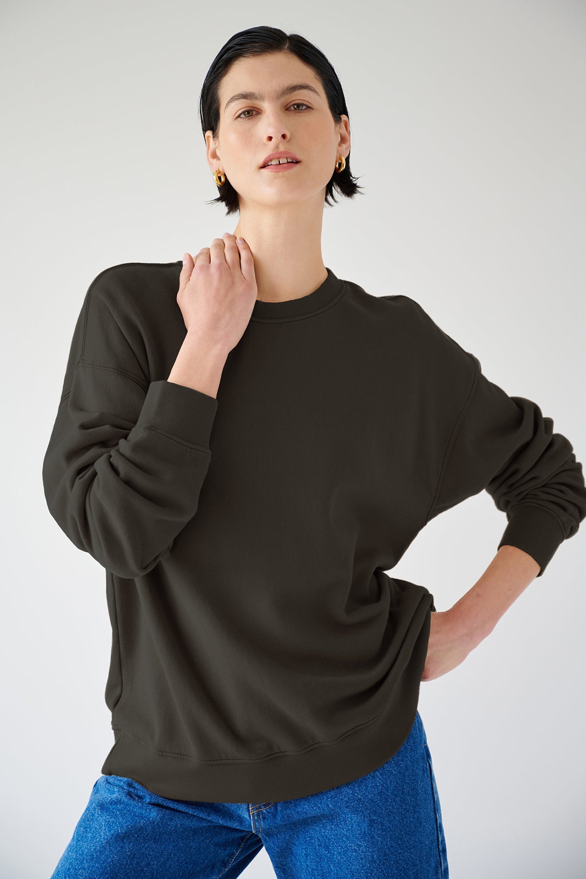 A woman rocking a slouchy black Velvet by Jenny Graham sweatshirt and jeans.-35200281149633
