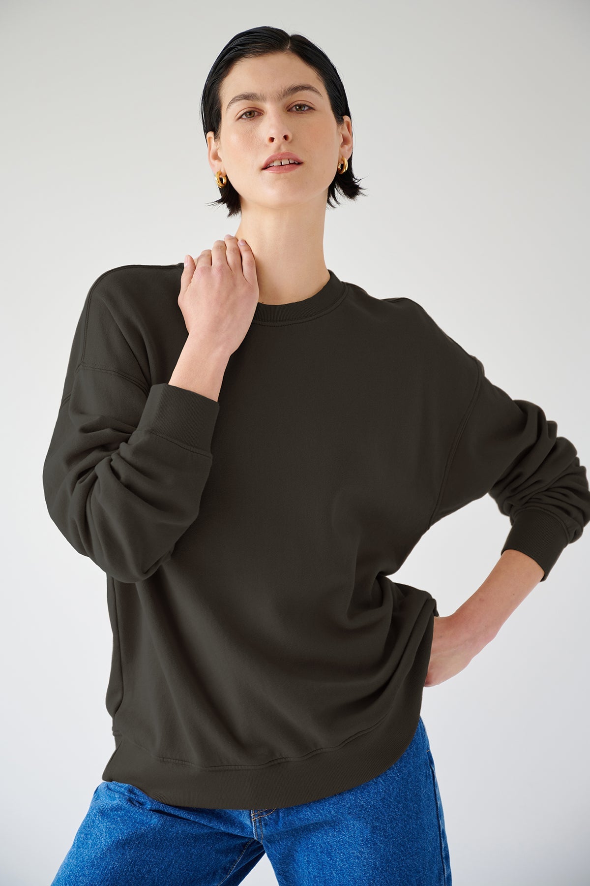 A woman rocking a slouchy black Velvet by Jenny Graham sweatshirt and jeans.-36594460688577