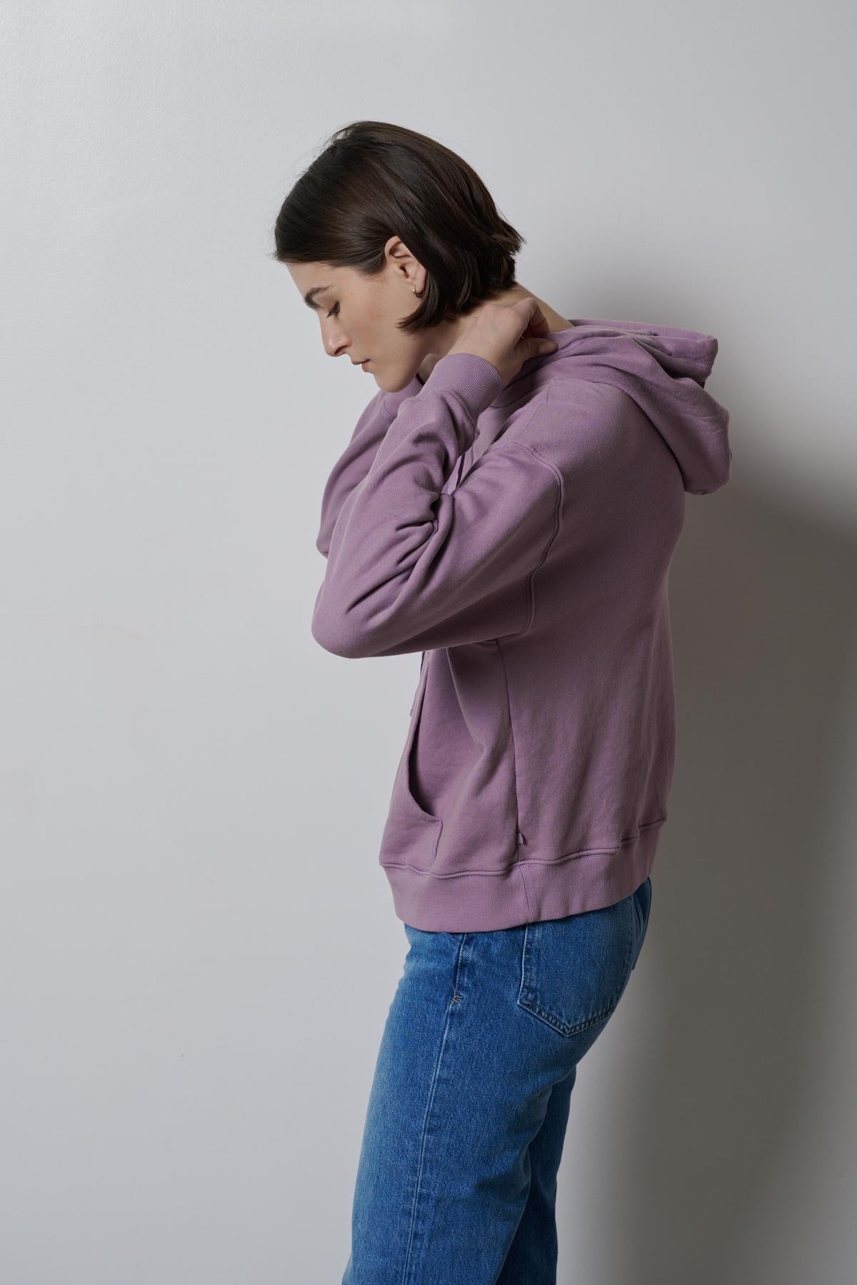 A woman wearing an OJAI HOODIE by Velvet by Jenny Graham and jeans.-35783045480641