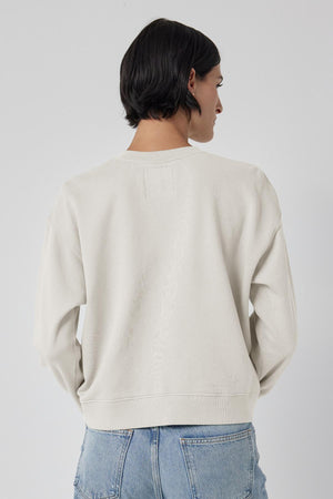 The back view of a woman wearing a Velvet by Jenny Graham YNEZ SWEATSHIRT and jeans.