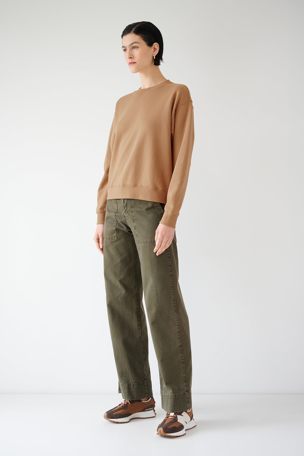   The model is wearing a YNEZ SWEATSHIRT by Velvet by Jenny Graham and brown pants. 
