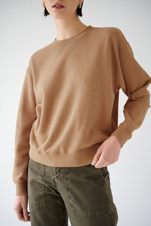 The model is wearing a YNEZ SWEATSHIRT made by Velvet by Jenny Graham and olive pants.