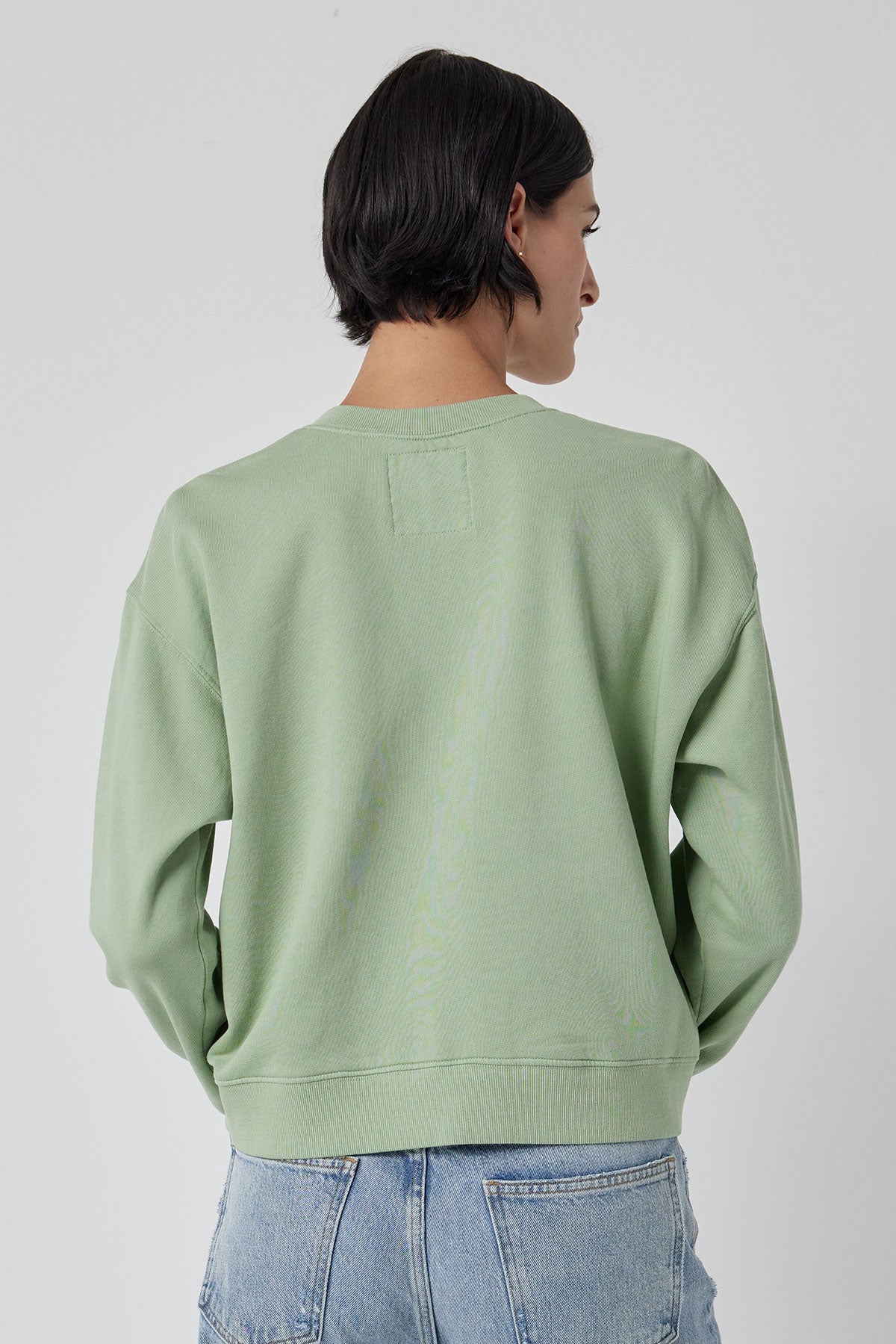   The back view of a woman in a Velvet by Jenny Graham YNEZ sweatshirt with dropped shoulders. 