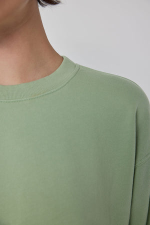 The back of a woman wearing a green Velvet by Jenny Graham YNEZ SWEATSHIRT.