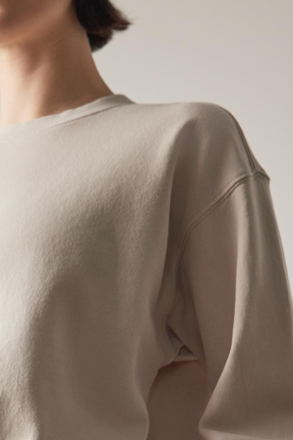   Rear view of a person wearing a Ynez Sweatshirt by Velvet by Jenny Graham, focusing on the shirt's texture and stitching details. 