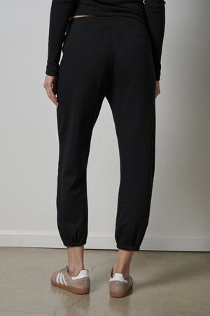 The back view of a woman wearing Velvet by Jenny Graham's ZUMA SWEATPANT made from organic fleece.