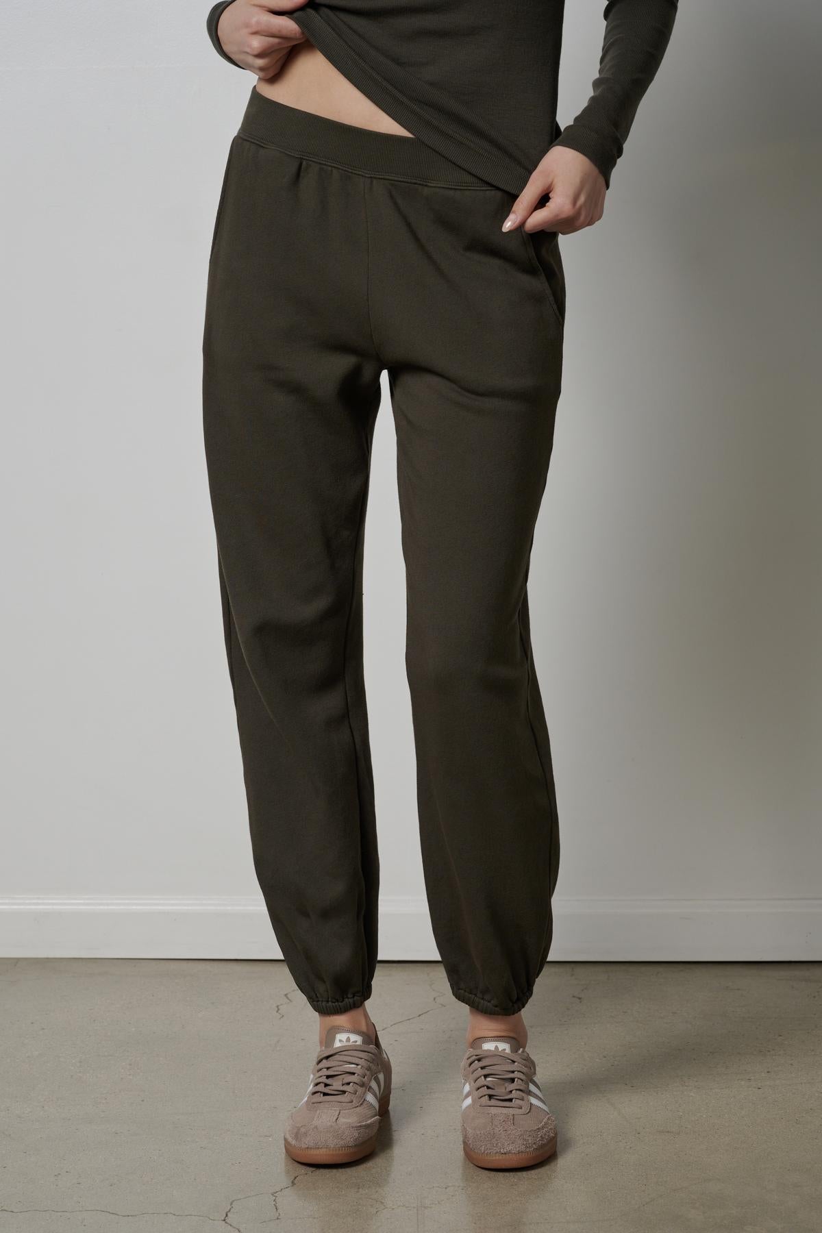   A woman wearing the Velvet by Jenny Graham ZUMA SWEATPANT in olive green. 