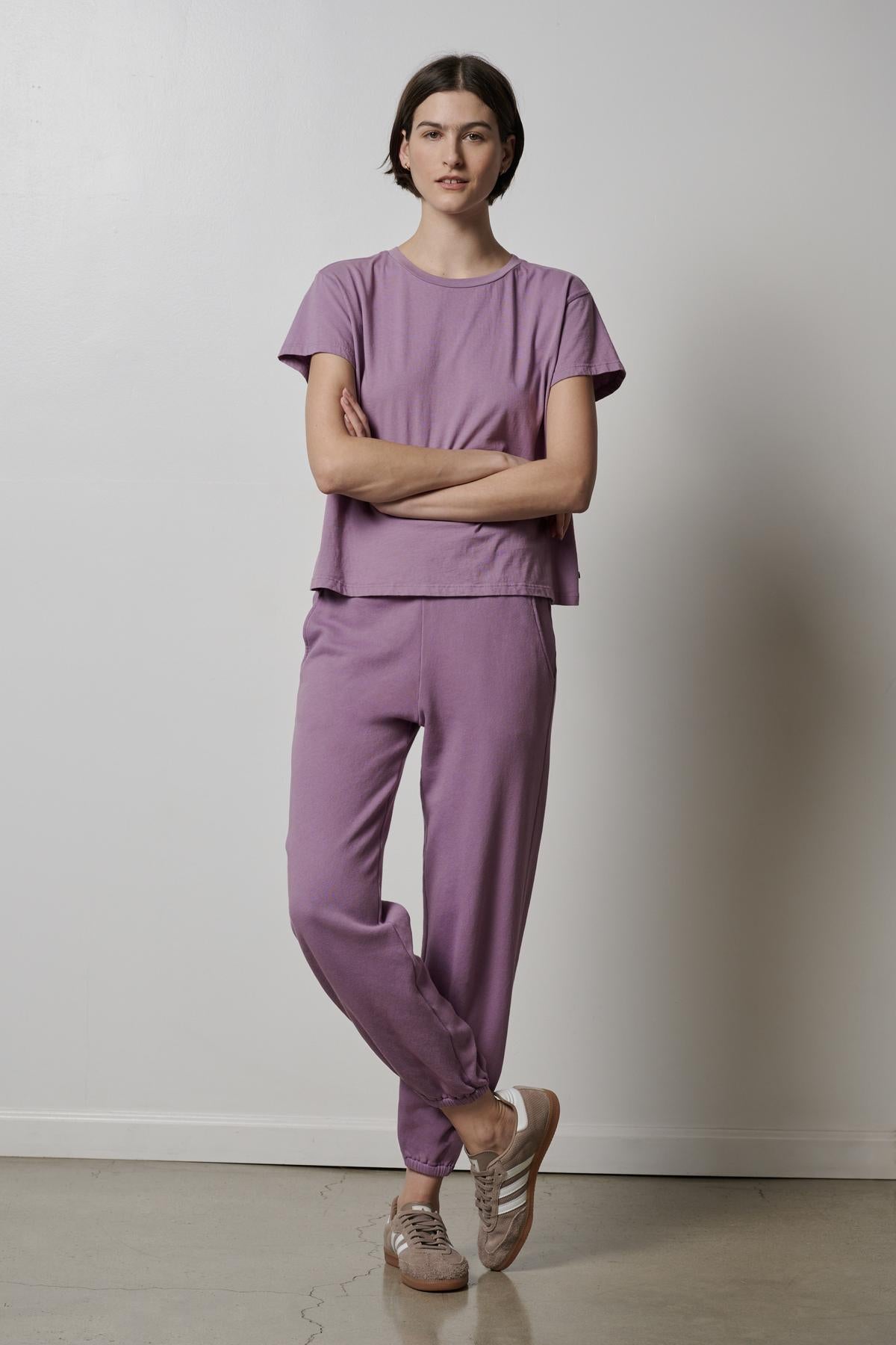 A woman wearing a lavender tee and Velvet by Jenny Graham ZUMA SWEATPANT joggers.-26827763548353