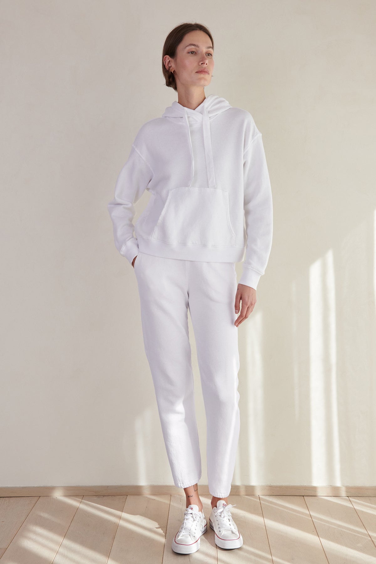 a woman wearing ZUMA SWEATPANTS by Velvet by Jenny Graham and a white hoodie.-26479722594497