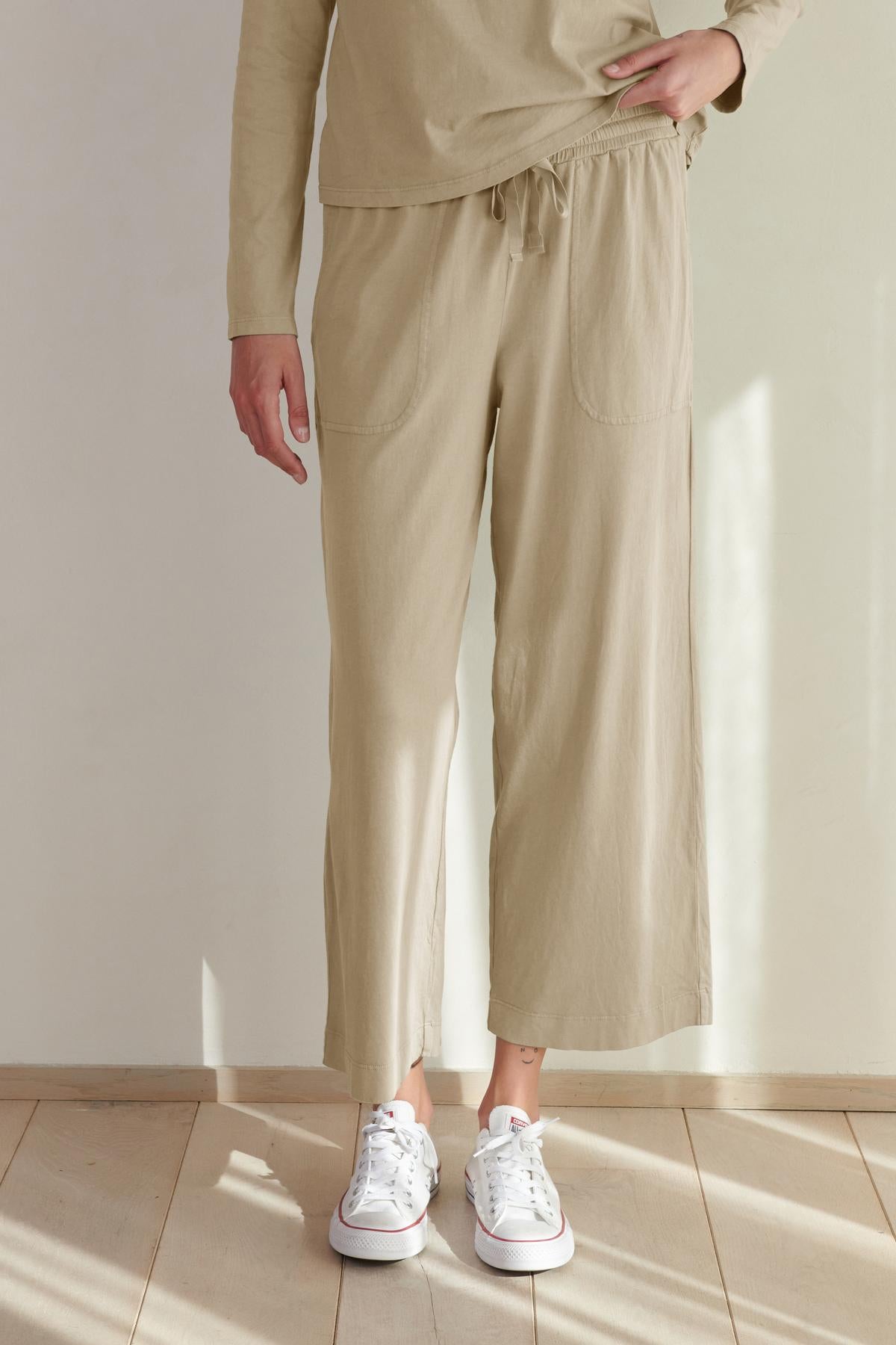 A person standing in a room wearing Velvet by Jenny Graham's PISMO PANT and white sneakers.-36463776465089