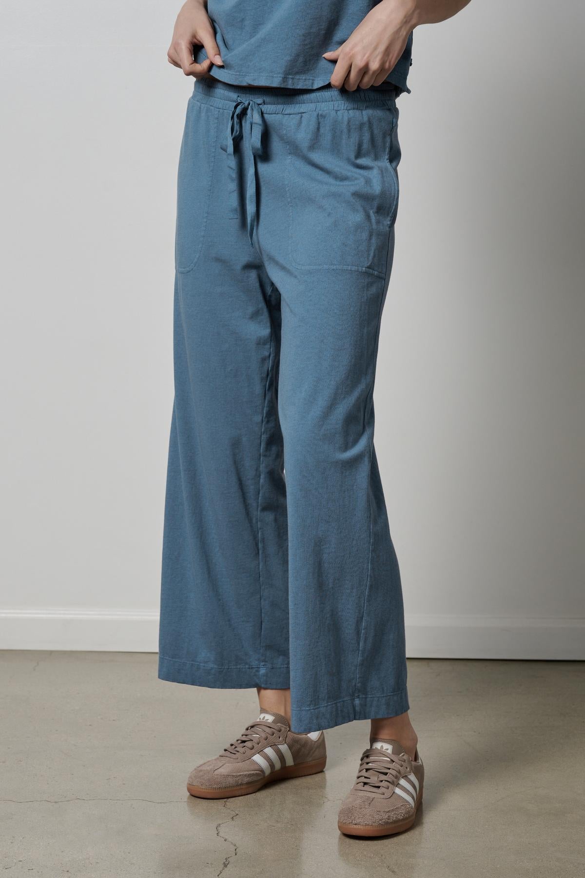   A woman wearing a Velvet by Jenny Graham PISMO PANT with elastic waist and sneakers. 