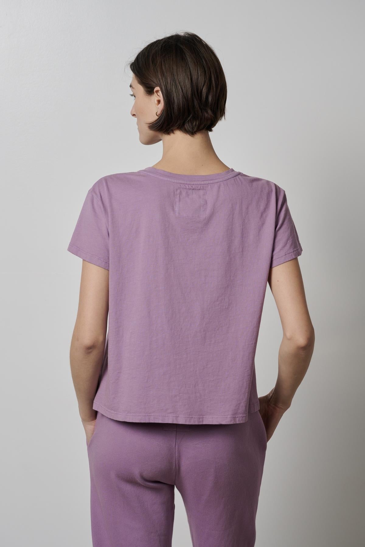   The back view of a woman wearing a Velvet by Jenny Graham TOPANGA TEE and pants. 
