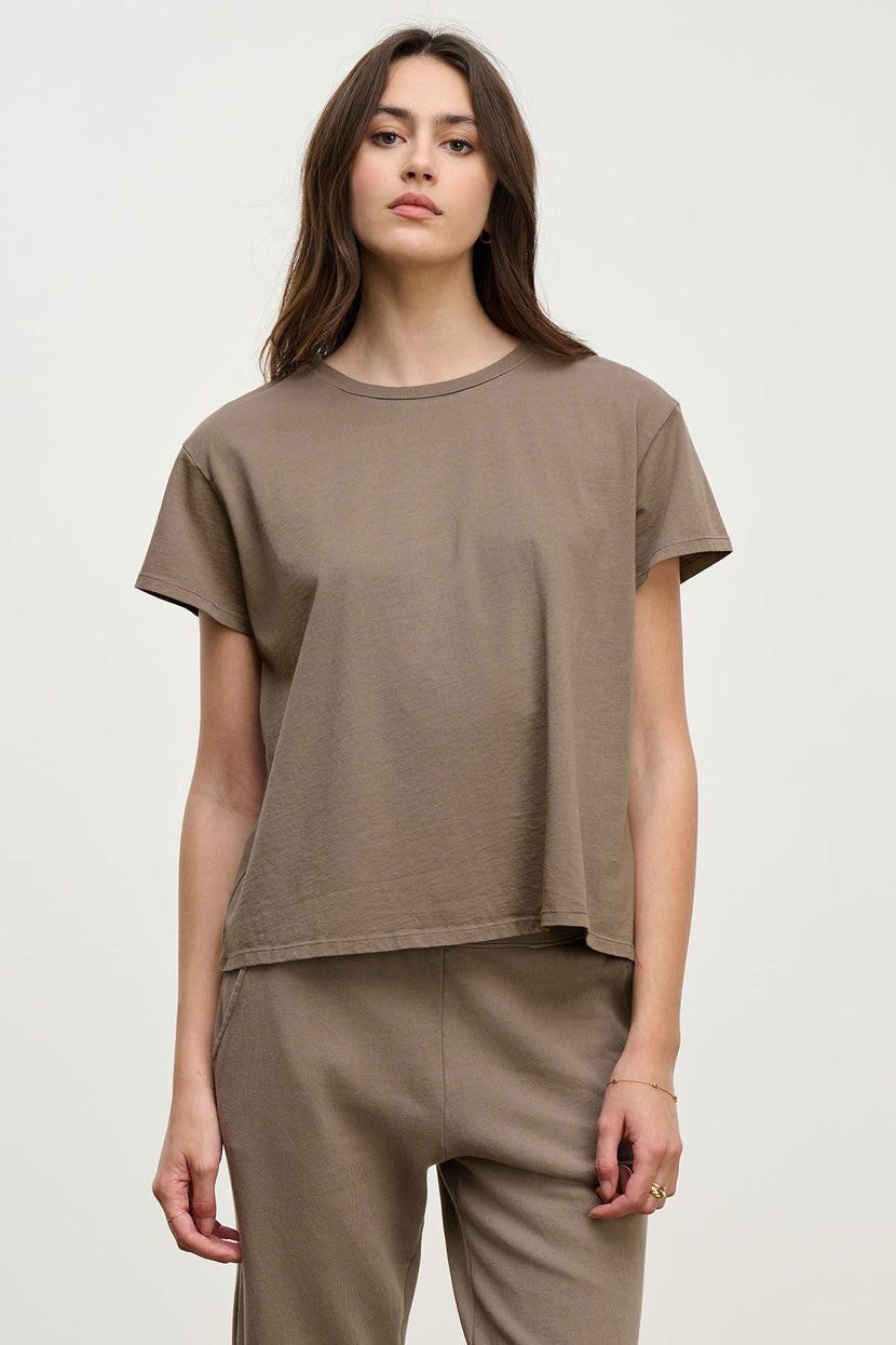 A woman models the Velvet by Jenny Graham TOPANGA TEE, a relaxed-fit organic cotton top, paired with matching pants against a plain light background.