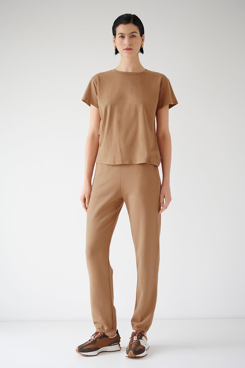 The model is wearing a tan t-shirt and Velvet by Jenny Graham ZUMA SWEATPANT.