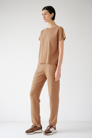 The model is wearing a tan t-shirt and Velvet by Jenny Graham ZUMA SWEATPANT.