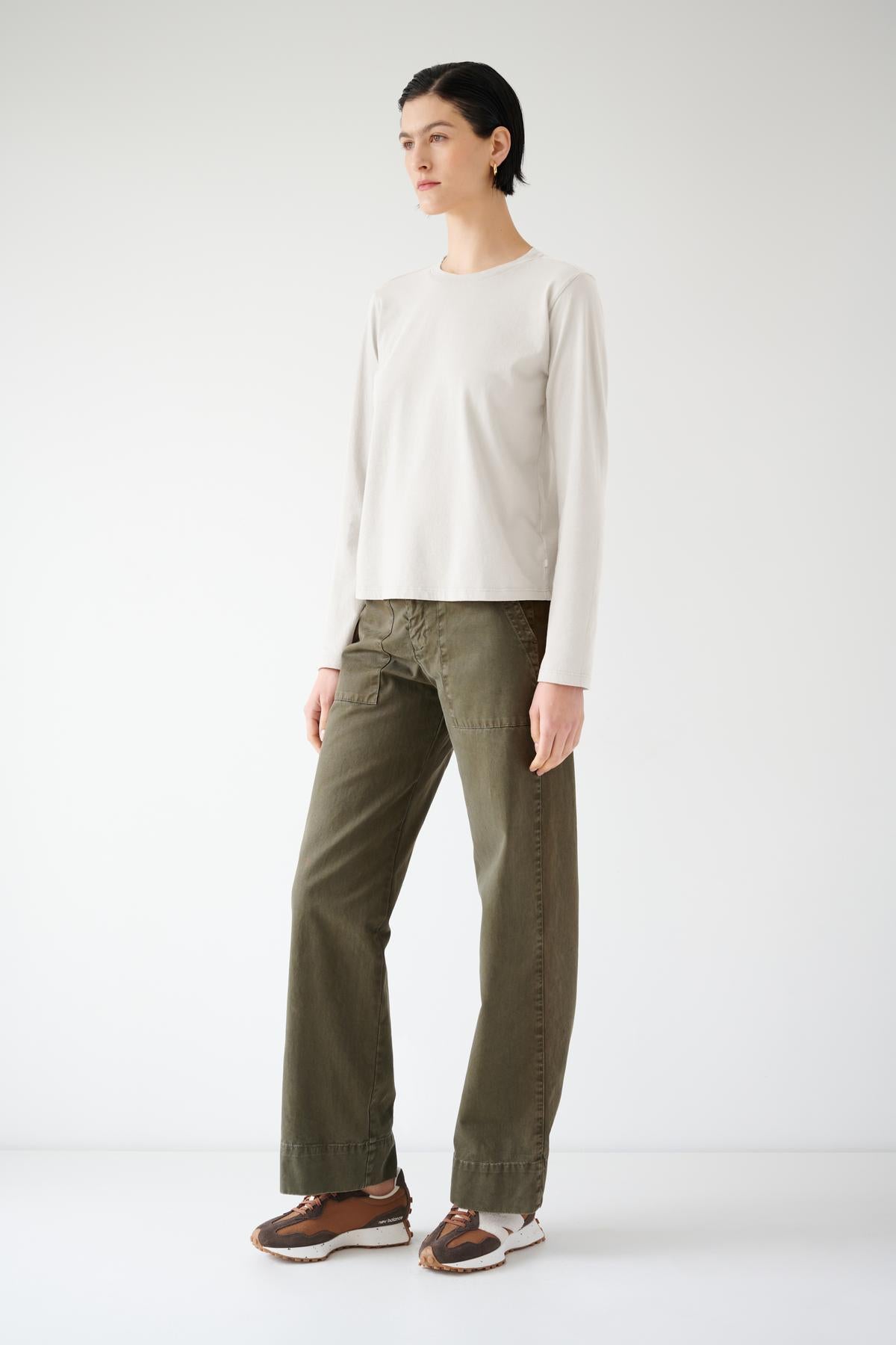   The model is wearing a relaxed fit VICENTE TEE shirt and olive pants made from organic cotton. (Brand: Velvet by Jenny Graham) 