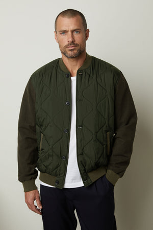 A man wearing a MAISON quilted jacket by Velvet by Graham & Spencer that combines functionality and style.
