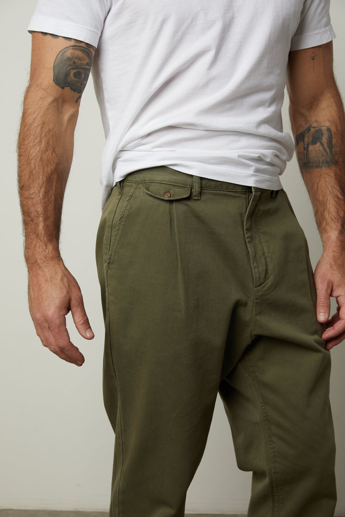   A man wearing Velvet by Graham & Spencer VINNY COTTON CANVAS PANT khaki pants and a white t-shirt with straight-fit leg. 