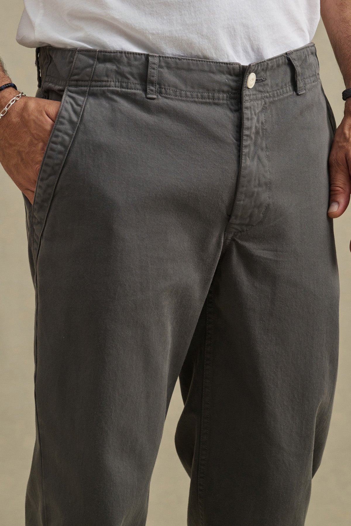 A person wears the LENNOX PANT by Velvet by Graham & Spencer—relaxed-fit cotton twill pants, shown from waist to mid-thigh with hands in pockets—ideal for everyday wear.