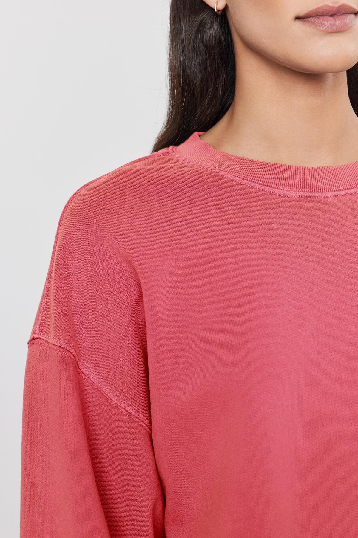   A close up of a woman's Velvet by Graham & Spencer SKYLAR SWEATSHIRT. 