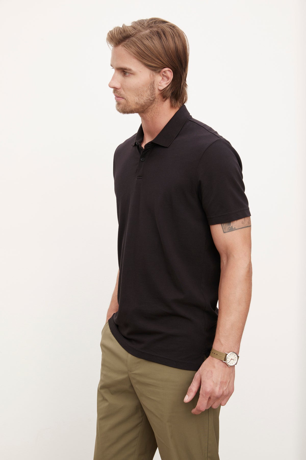   A man wearing a Velvet by Graham & Spencer Willis Pique Polo shirt and khaki pants. 
