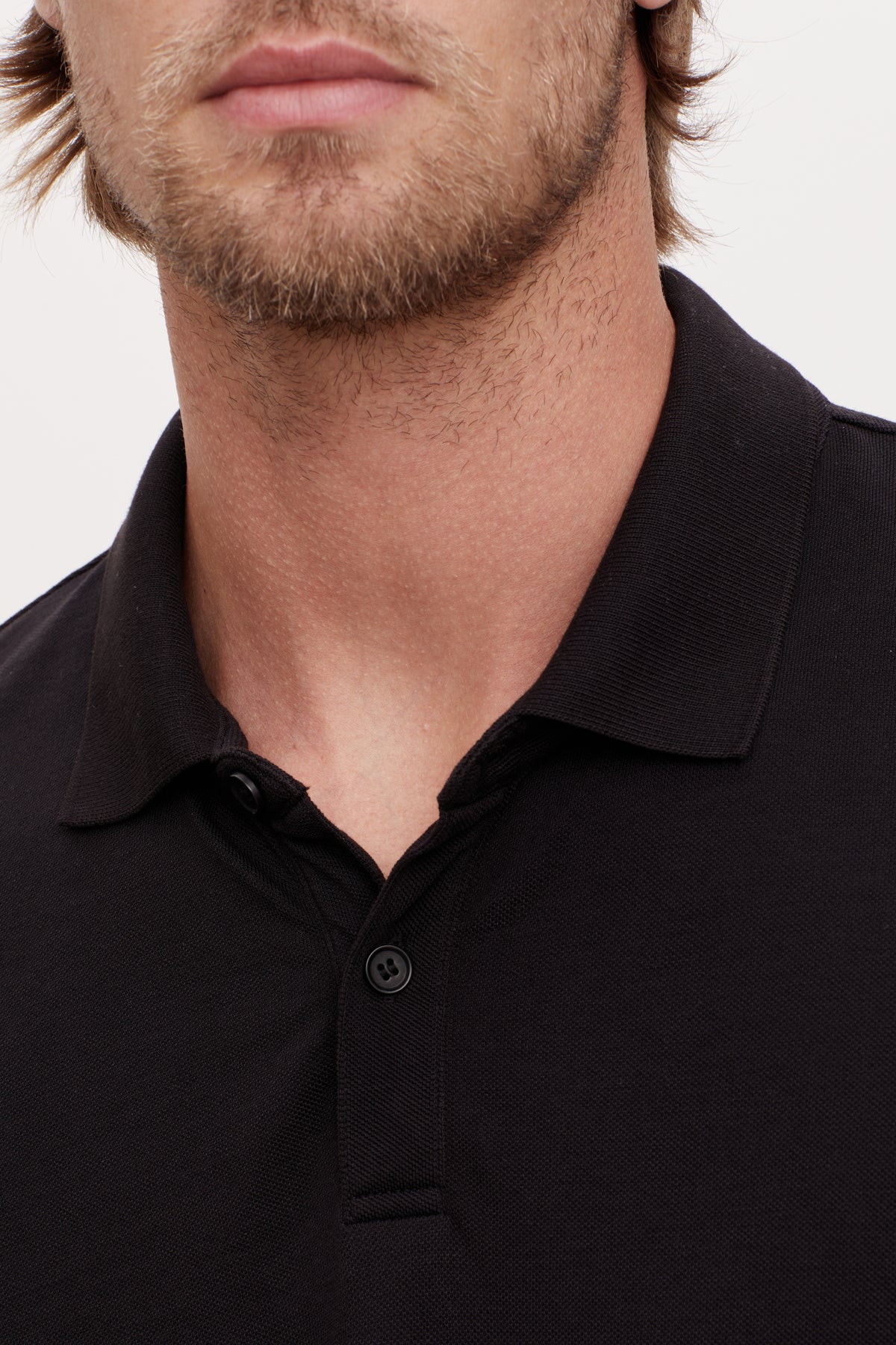   A man wearing a black Velvet by Graham & Spencer Willis Pique Polo shirt. 