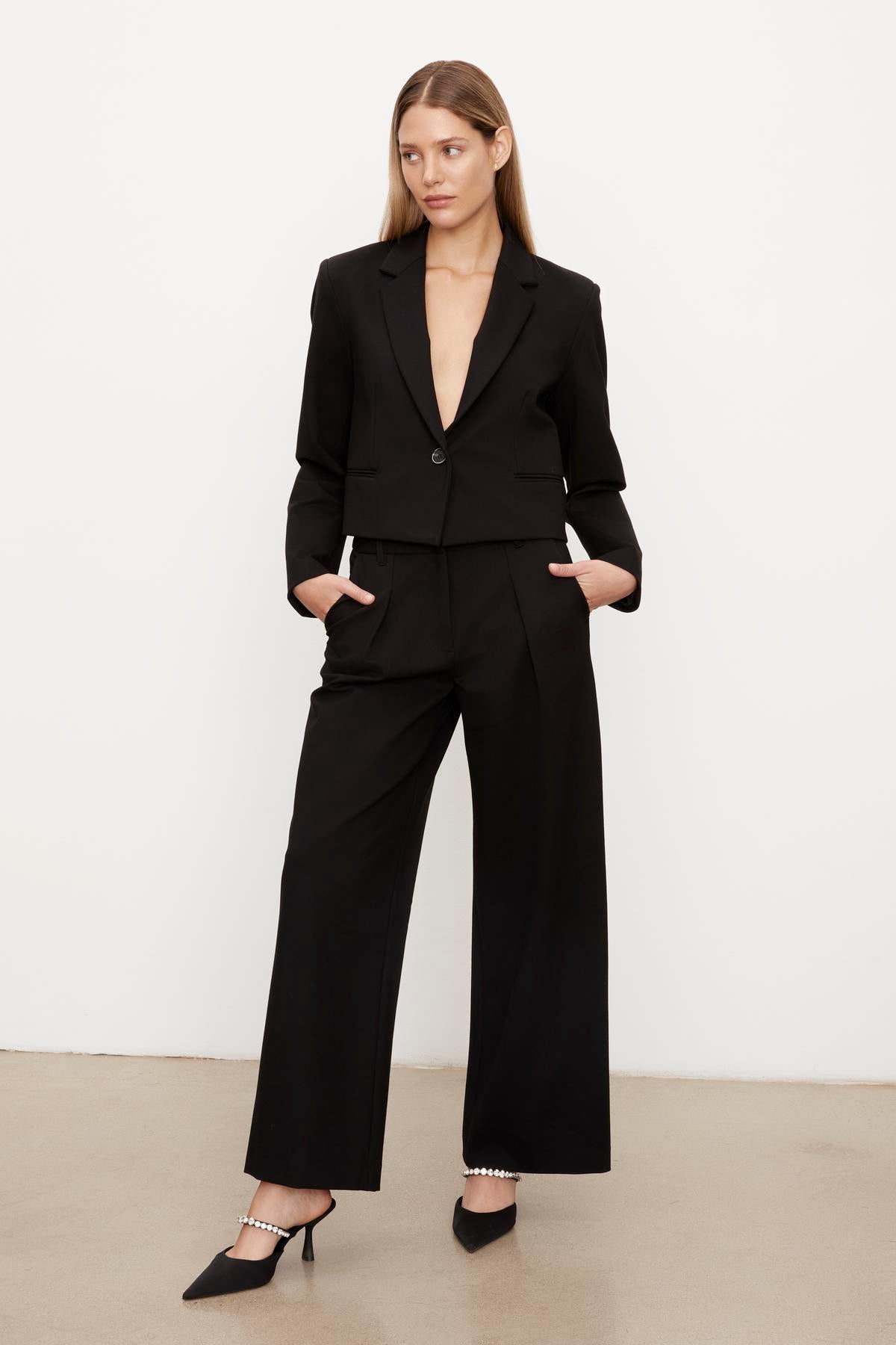   The model is wearing a double-layer ponti knit blazer with the Velvet by Graham & Spencer Leona wide leg ponti pant silhouette. 