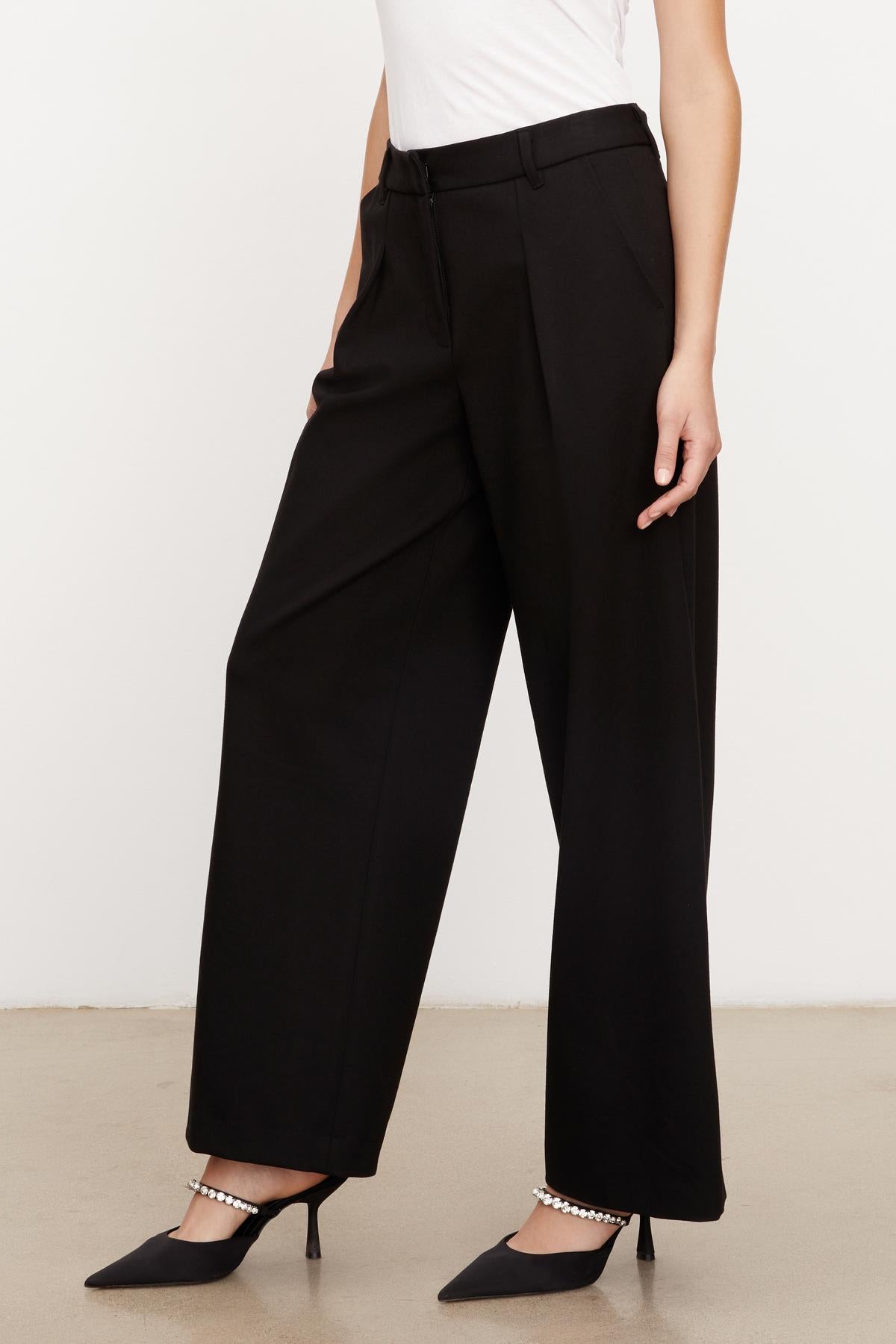   A woman wearing the LEONA WIDE LEG PONTI PANT by Velvet by Graham & Spencer. 