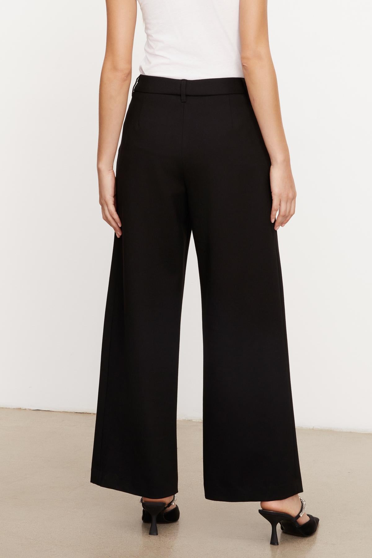 The back view of a person wearing Velvet by Graham & Spencer's LEONA WIDE LEG PONTI PANT.-35696188653761