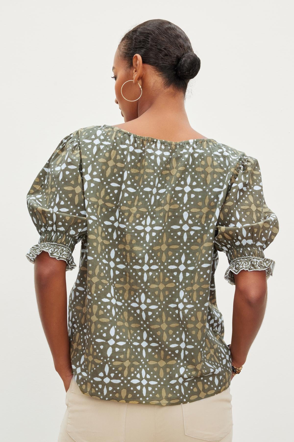 The back view of a woman wearing the Velvet by Graham & Spencer ALEX PRINTED BLOUSE.-26799971762369