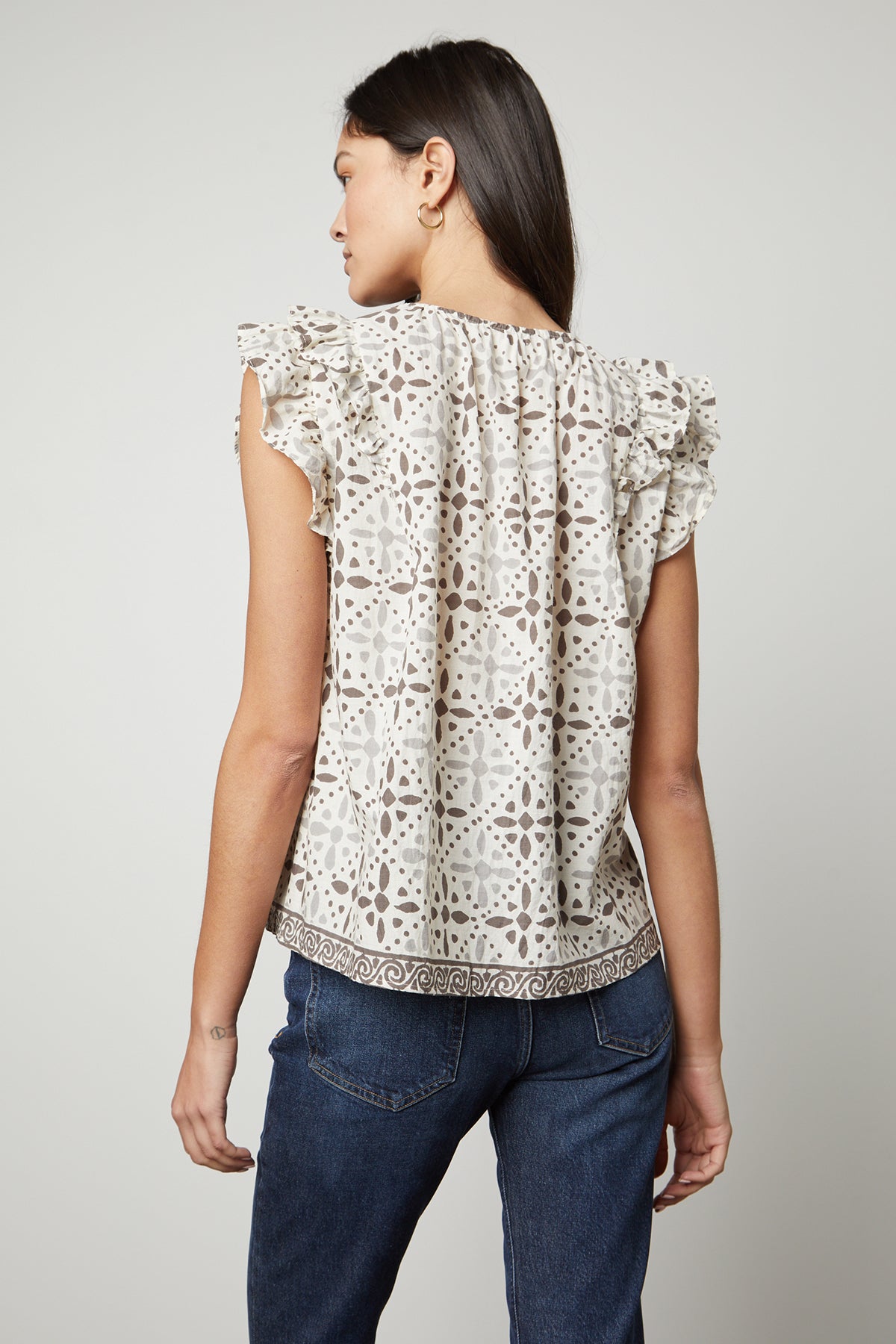   The back view of a woman wearing a CORIN PRINTED TANK TOP by Velvet by Graham & Spencer. 
