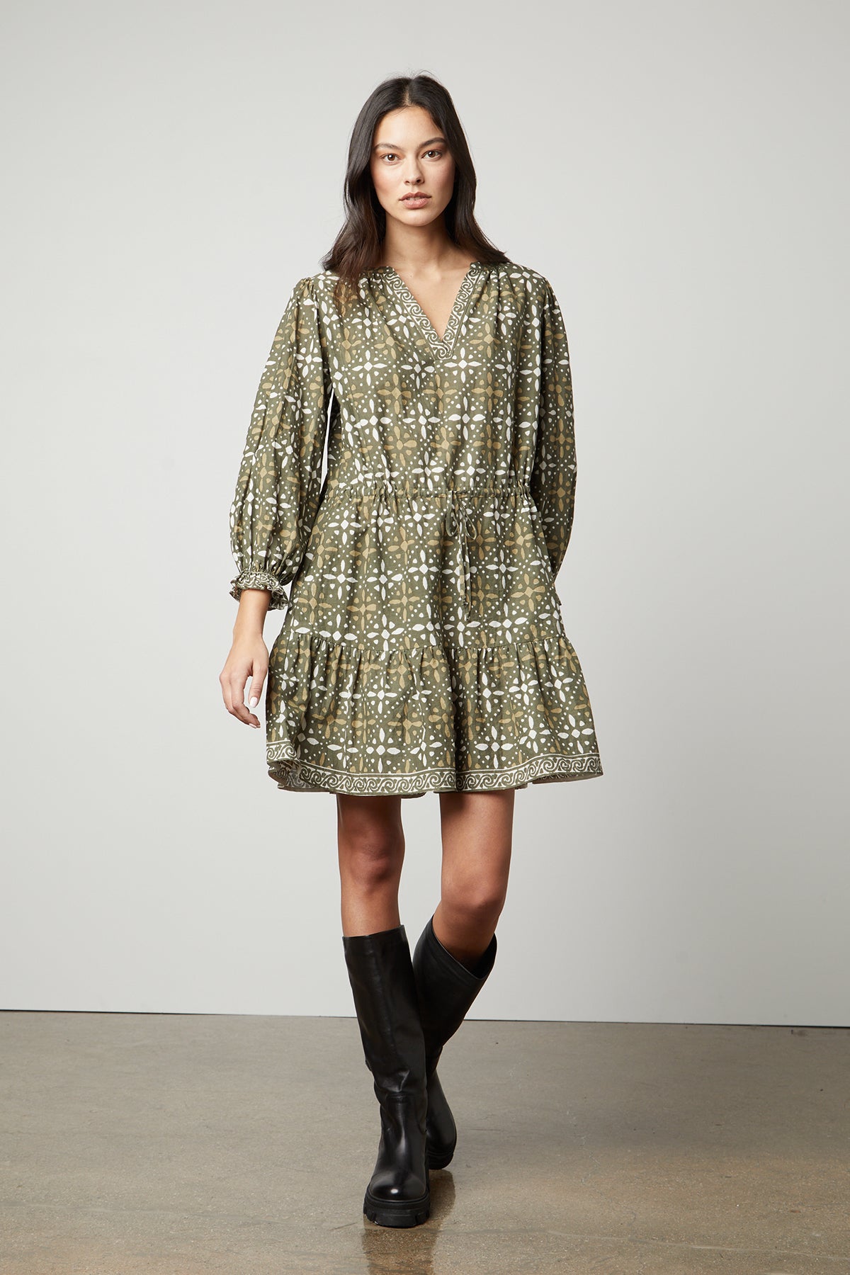 The model is wearing a KATARINA PRINTED BOHO DRESS by Velvet by Graham & Spencer with black boots.-26799891939521