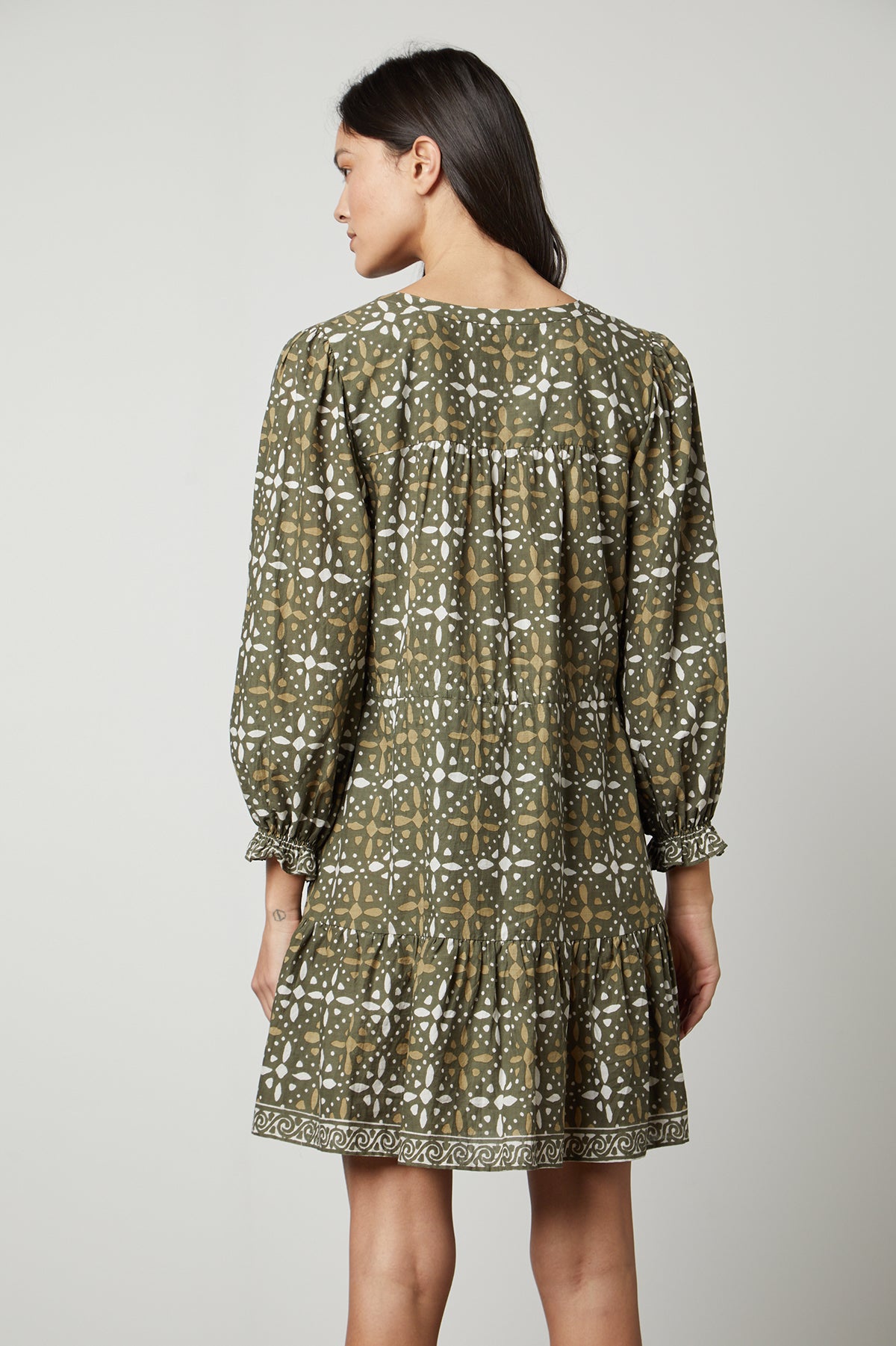   The back view of a woman wearing a Velvet by Graham & Spencer KATARINA PRINTED BOHO DRESS. 