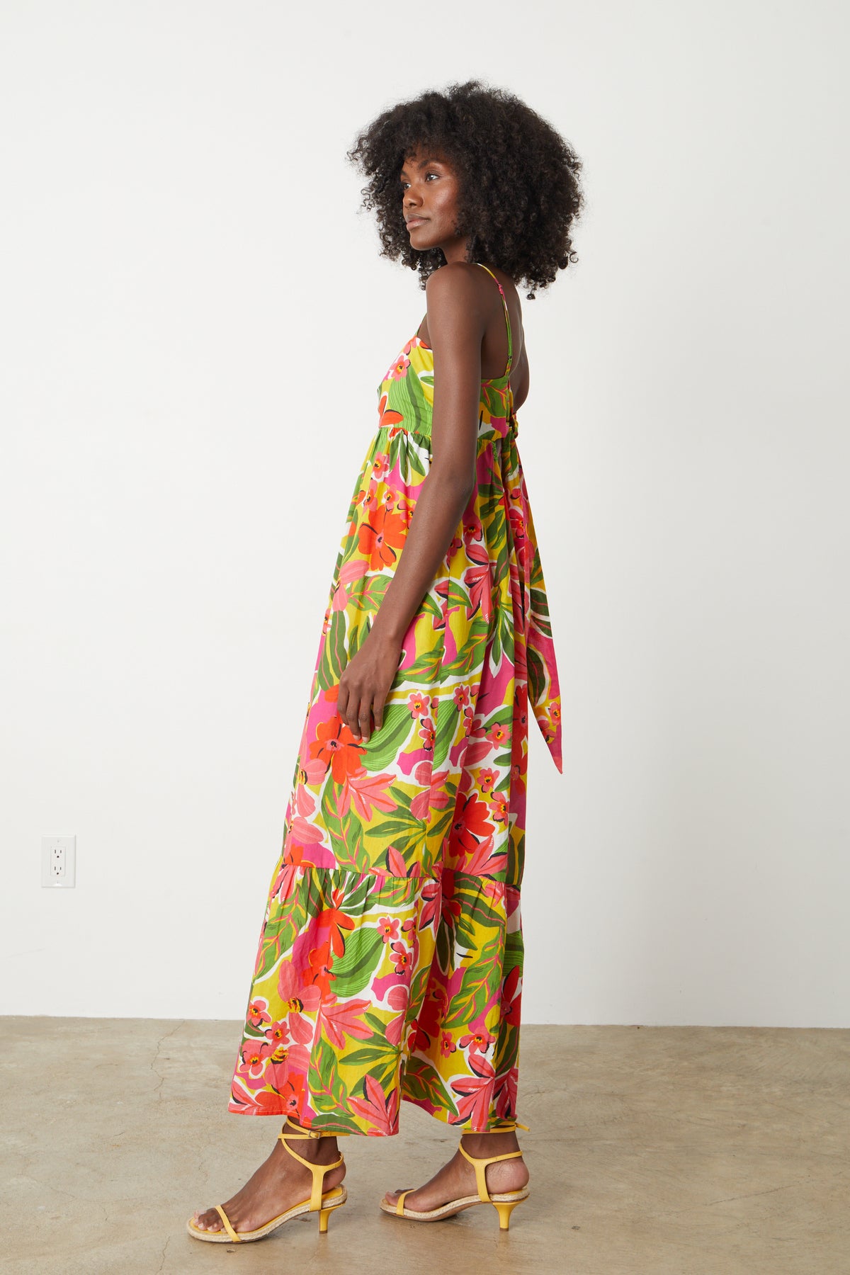   A black woman wearing the Velvet by Graham & Spencer Kayla Printed Maxi Dress. 