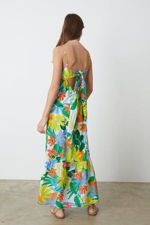 The back view of a woman wearing a Velvet by Graham & Spencer KAYLA PRINTED MAXI DRESS.