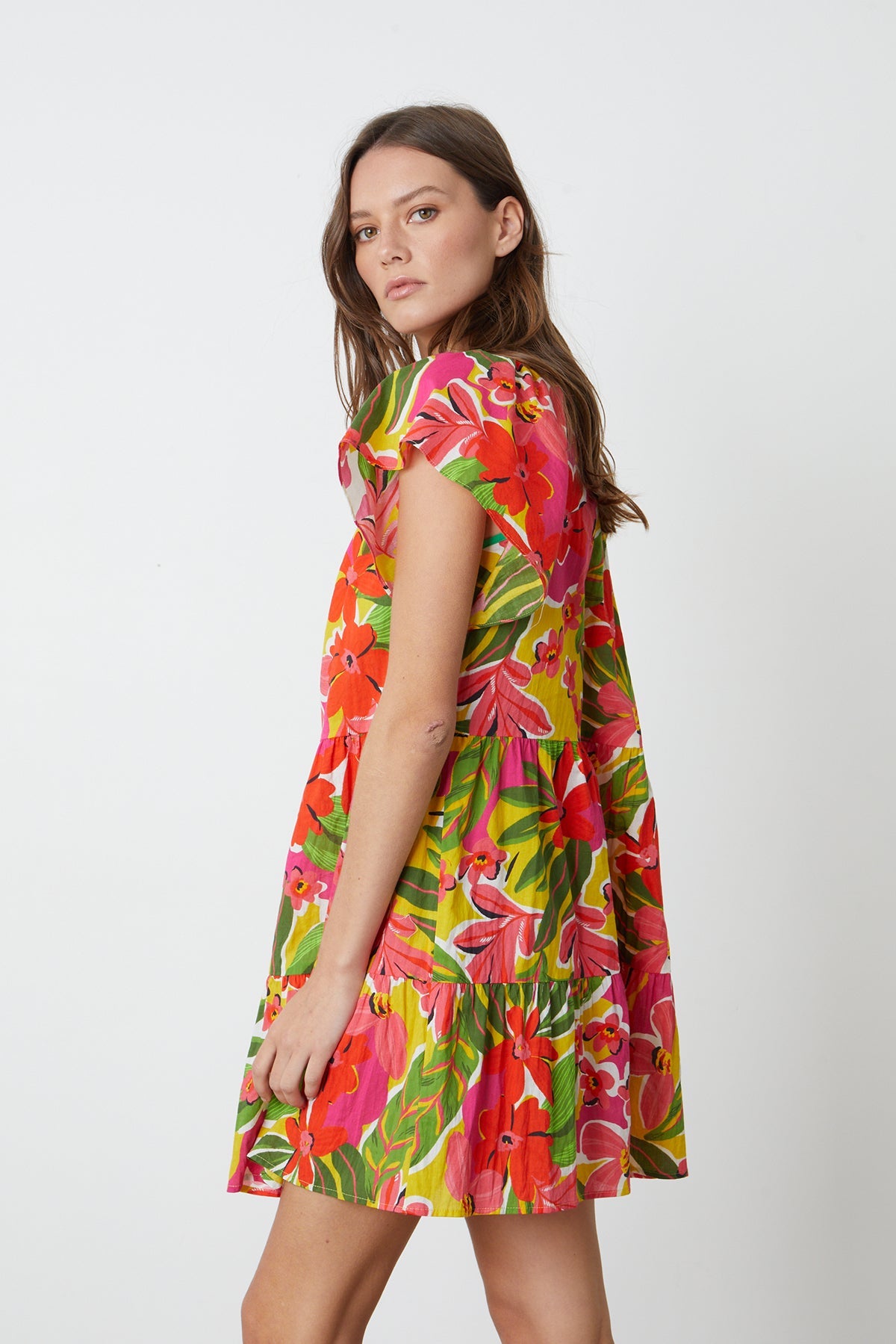   Maeve Tiered Dress in bold floral aloha print with reds, hot pinks and greens side 