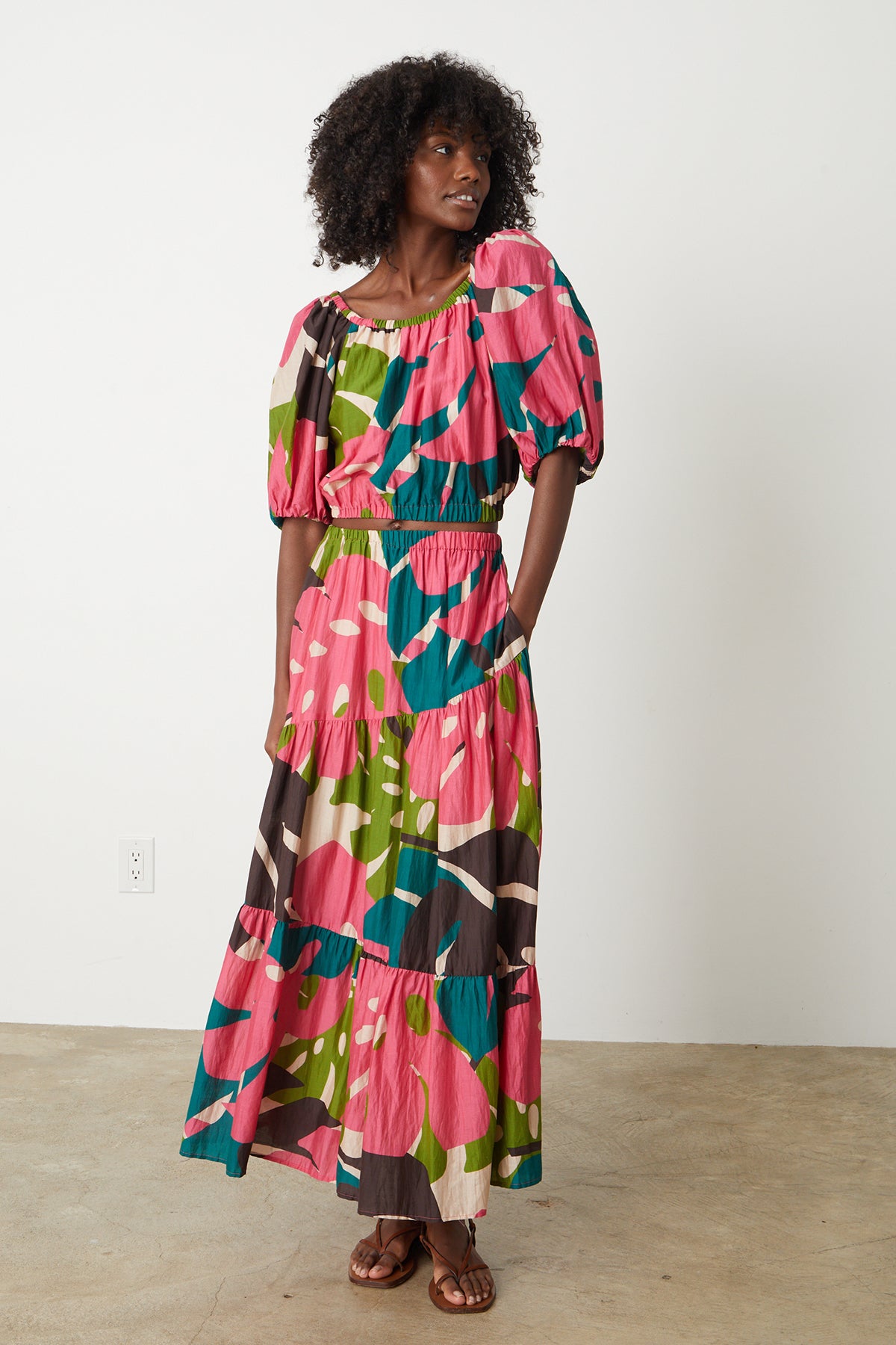 A woman wearing a Velvet by Graham & Spencer LYDIA PRINTED TIERED SKIRT maxi dress.-26342680953025
