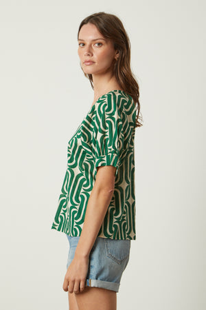 a woman wearing shorts and a Velvet by Graham & Spencer JODY PRINTED TOP.